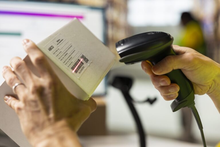 close up worker manages cargo barcode scanning distribution hub scaled 2