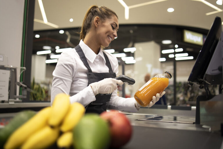 portrait female cashier supermarket scanning bar code products sale scaled 2
